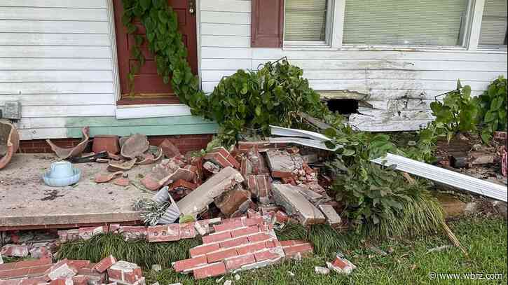 Central home damaged after vehicle careens off road, through fence and across yard