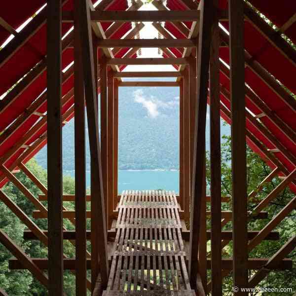 Oversized red roof shelters Patagonian Shadow Cabin in France