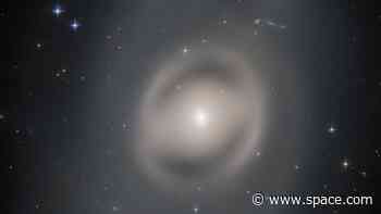 Hubble telescope captures a 'ghostly' galaxy glowing in distant space (photo)