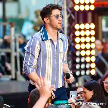 Nick Jonas falls through hole during performance