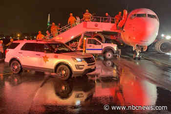 Sparks fly from Alaska Airlines plane after it lands in Southern California during Tropical Storm Hilary