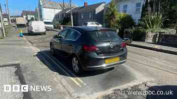 Car moved after roadworks crew resurface around it