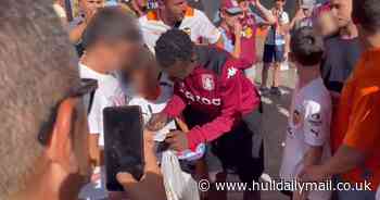 Watch: Baffled footy fan 'mistaken for Premier League star' and hounded by 'hundreds' - so poses for snaps and autographs