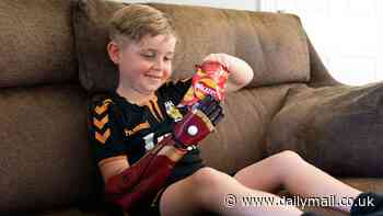 Heartwarming moment seven-year-old boy born with missing limb tries out his new Iron Man-themed bionic arm