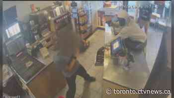 Security footage shows brazen gunpoint robbery at Toronto fast food restaurant