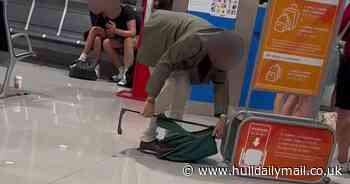 Frustrated easyJet passenger filmed destroying own luggage in a bid to squeeze into airline's bag check frame