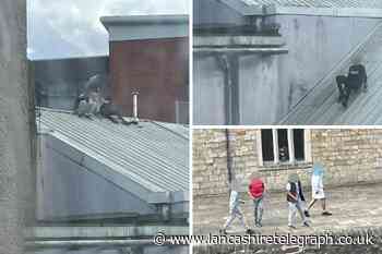 Youths caught on CCTV climbing Accrington town centre roof