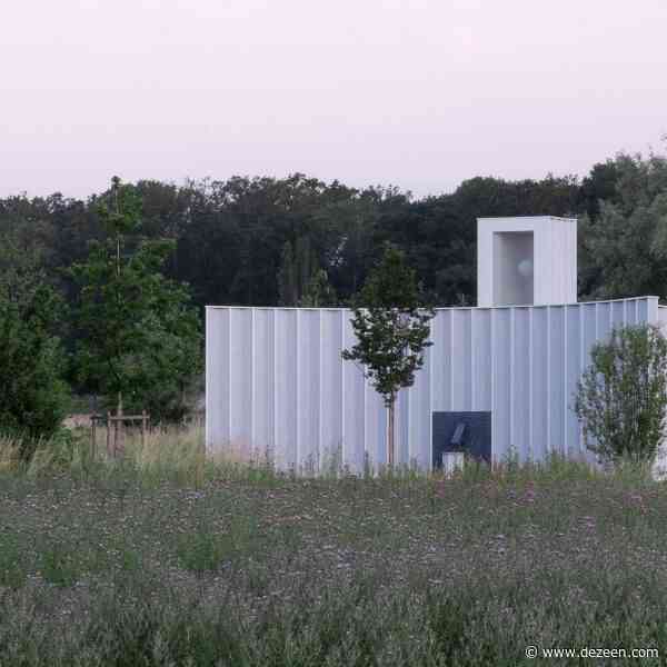 Blue-timber gardeners' workshop topped with illuminating lantern