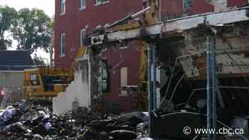 City of Winnipeg crews knock down walls of business destroyed in February fire — but rubble pile remains