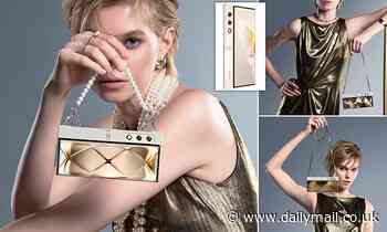 World's first handbag-inspired smartphone is revealed: Bizarre foldable device looks like a purse and is decked out in chains, feathers and tassels