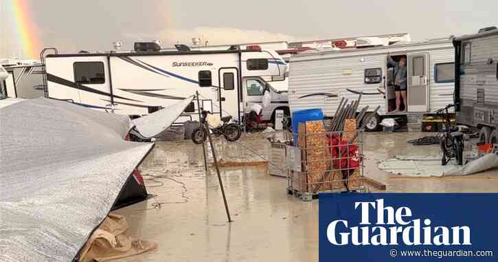 Burning Man festival-goers trapped in desert as rain turns site to mud