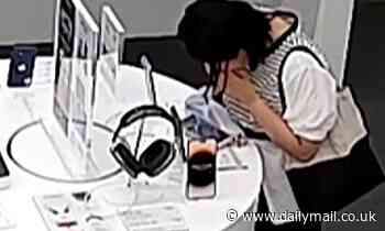 Watch the unbelievable moment a woman attempts to BITE through an anti-theft cable in a bizarre bid to steal an iPhone 14 Plus