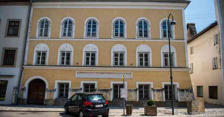 Deutscher steht mit aufgemalten NS-Symbolen auf Stadtplatz