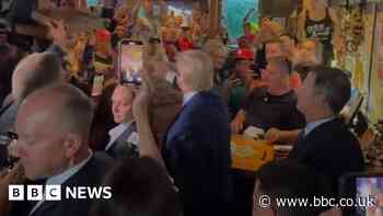 Trump hands out pizza at Iowa pub