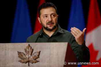 Ukraine's Zelenskiy Stops Over in Poland to Award Two Volunteers