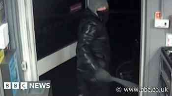 Moment armed robber storms Grimsby store in raid