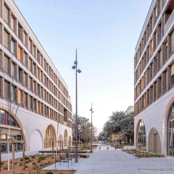 Concrete arches overlook public square at Pôle Laherrère apartment blocks in France