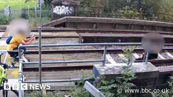 CCTV shows moment couple pose for photo on train tracks
