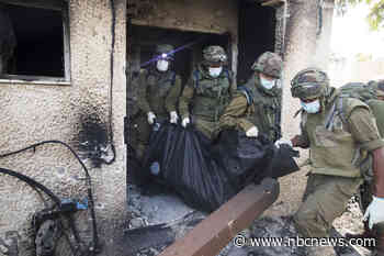 'It’s a massacre': Bodies of victims still strewn across kibbutz once home to 700