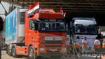 First trucks carrying aid for Palestinians cross into Gaza from Egypt