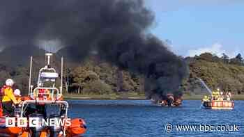 Two rescued from boat destroyed by fire