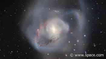 Earth's nearest supermassive black hole pair lies in the wreckage of a galactic collision