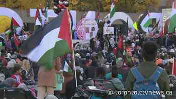 Thousands of pro-Palestinian demonstrators move through downtown Toronto streets