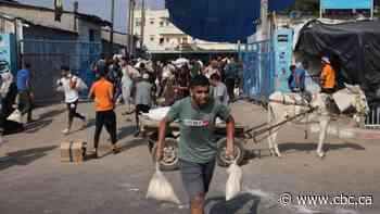Thousands break into aid warehouses in Gaza as Israeli airstrikes continue, UN agency says