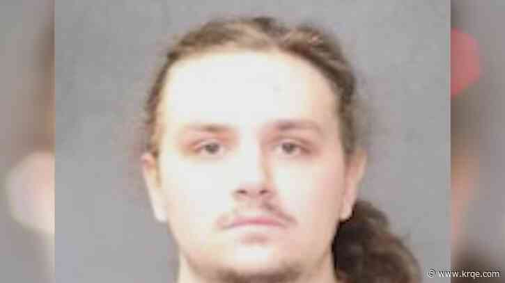 Man faces gun charges after found with man linked to killing near Isotopes Park