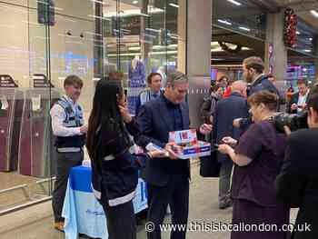 Sir Keir Starmer gives out poppies at Kings Cross Station