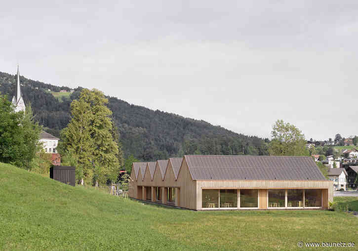 Eine Dorfstraße mit sechs Satteldächern
 - Kindergarten von Bernardo Bader Architekten in Vorarlberg