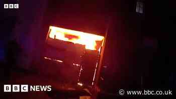 Two rescued as police storm building hit by blaze