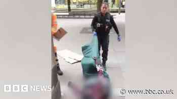 Police officer drags homeless man along ground