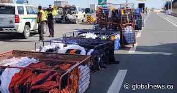 Racks of uniform linens fall out of truck on Highway 401 near DVP/404