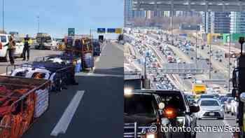 Linen racks tumble off truck causing heavy traffic on Highway 401 in Toronto