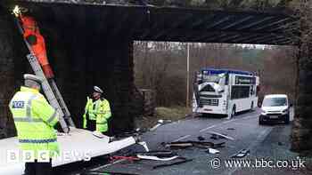 Double decker bus roof ripped off in bridge crash