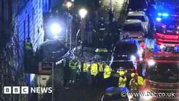 Man reported after car crashes into tenement
