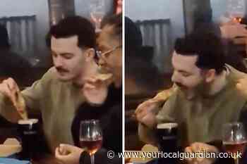 Man dips Domino's pizza into Guinness at King's Cross pub