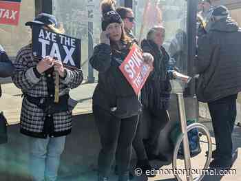 Dozens march down Edmonton's Jasper Avenue to protest federal carbon tax