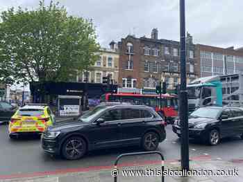 Holloway Road: Traffic blocked as man lies injured on ground