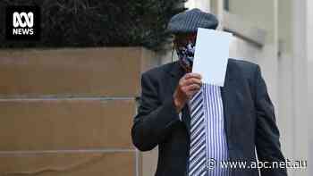 As cameras followed him, a paedophile held up an item with his victim's name on it