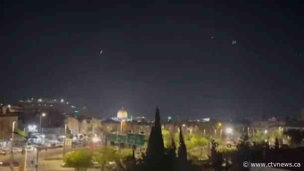 Booms and sirens in Israel after Iran launches ballistic missiles and drones in unprecedented attack