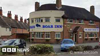 Assault charge after police spat at in pub