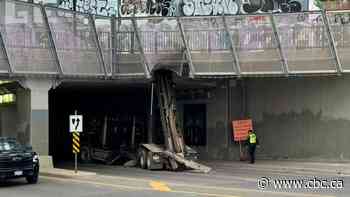 Truck hits Queen and Dufferin bridge, road closures in area