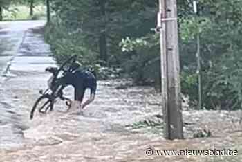Wielertoerist trotseert regenweer, maar wordt dan door water meegesleurd