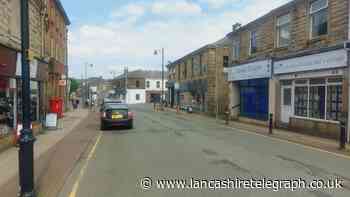 Accrington Road closed after man scales roof of property