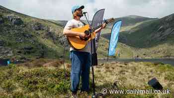 'The hills were alive with the sound of music': Music fans hike up to seven hours to 'UK's most remote gig' - at a reservoir deep in the Snowdonia mountains
