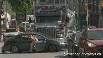 Video shows driver frantically getting out of car being pushed by truck on Avenue Road