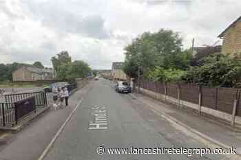 Police descend on Darwen after wanted man spends hours on roof