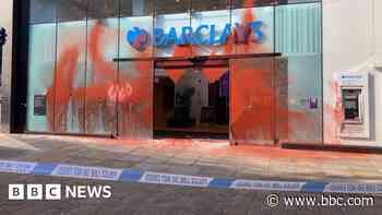 Four arrested after Barclays bank covered in paint